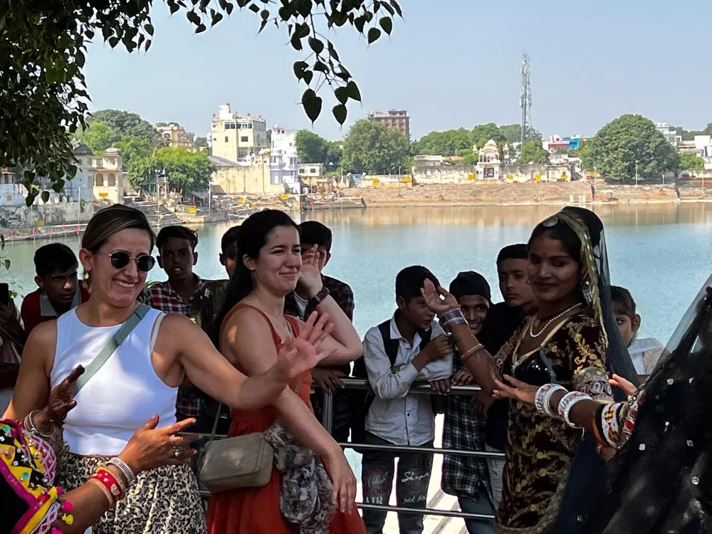 Travelers and local residents gathered beside Pushkar Lake