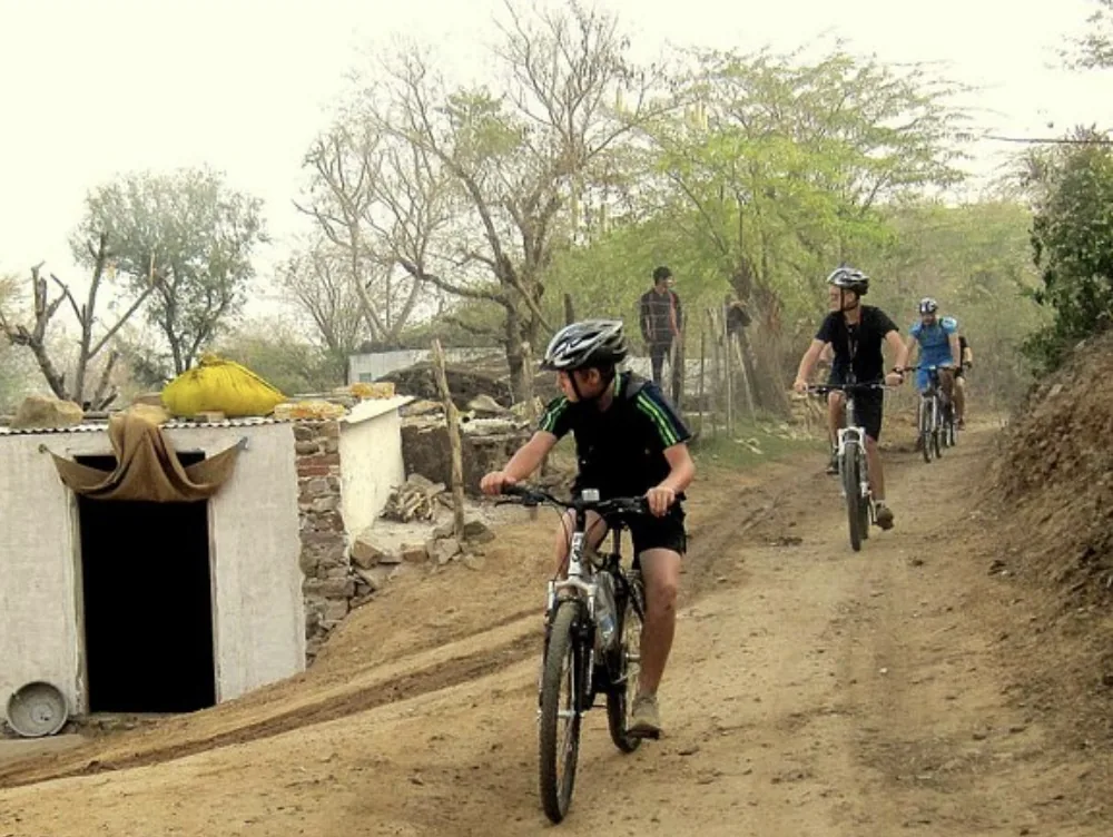 Cyclists follow a rural trail around Pushkar