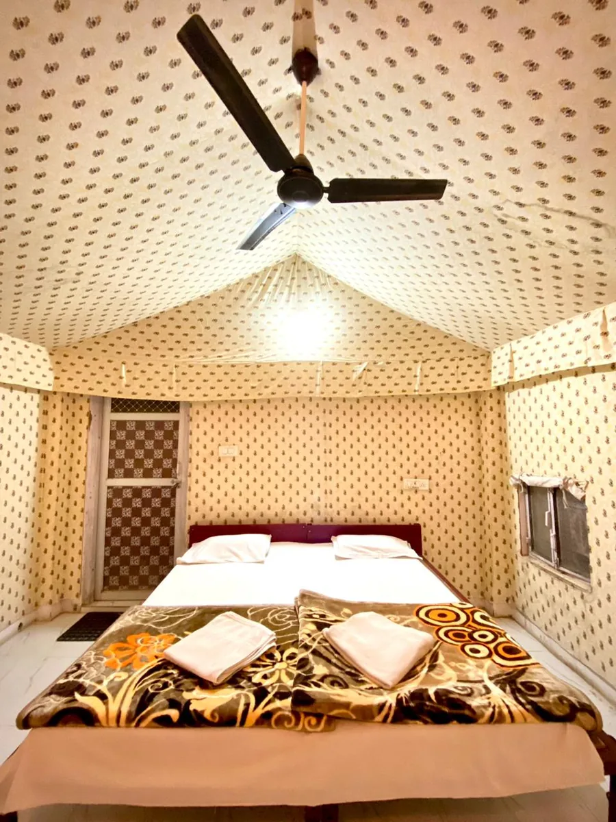 A bed inside traditional desert camp accommodation