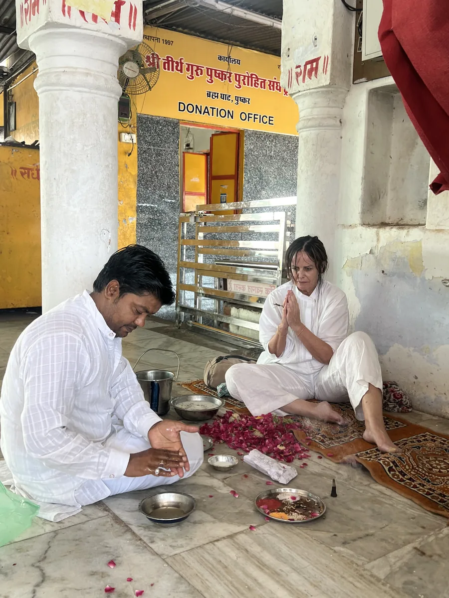 A visitor makes offerings during a Pushkar ritual