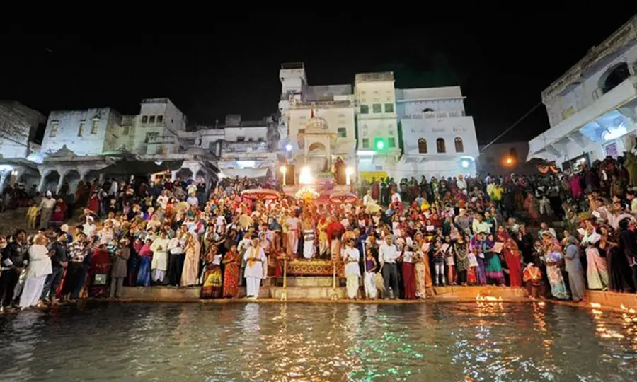 A crowd gathers for evening rituals at Pushkar Lake