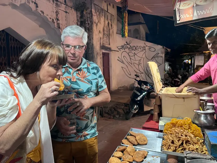 A traveller tastes food during a Pushkar market walk
