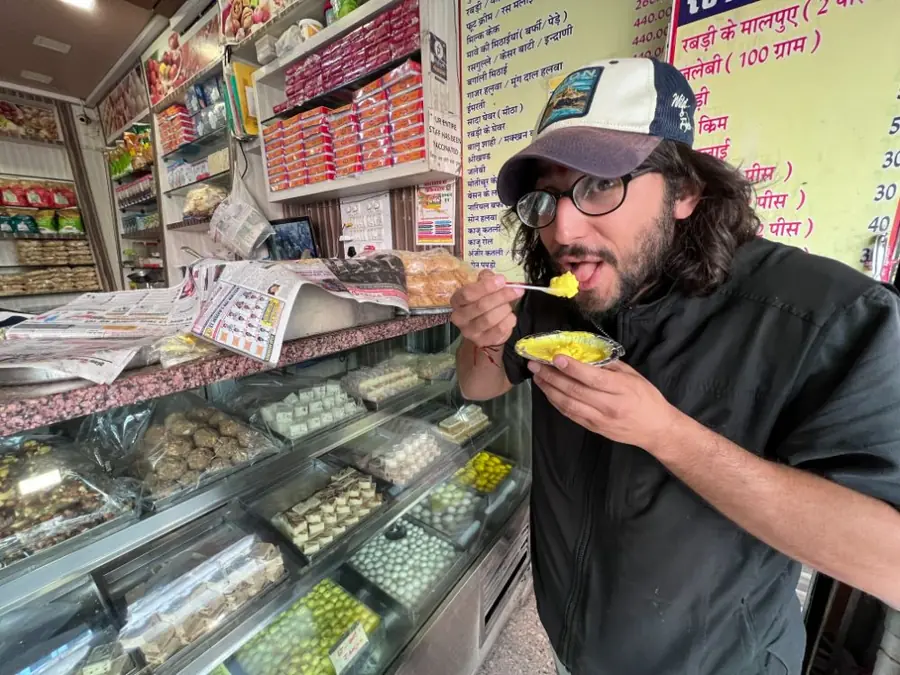 A visitor samples food at a small local stall